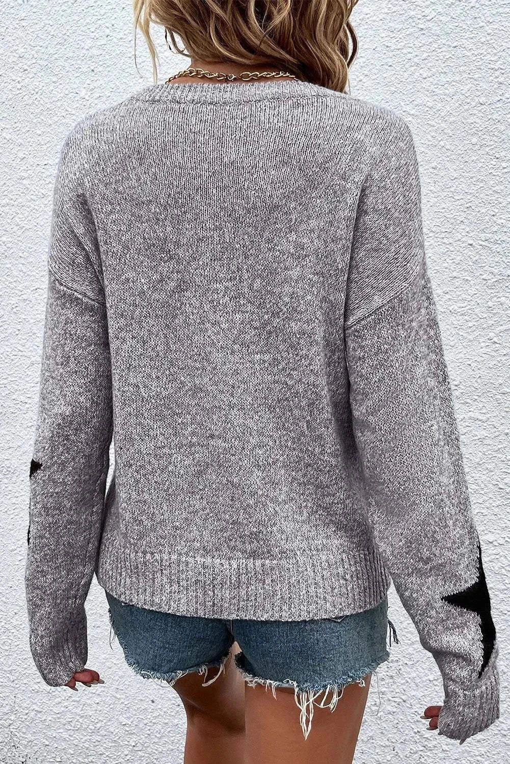 Gray Star Round Neck dropped shoulder sweater with star pattern on sleeves, worn with denim shorts, back view