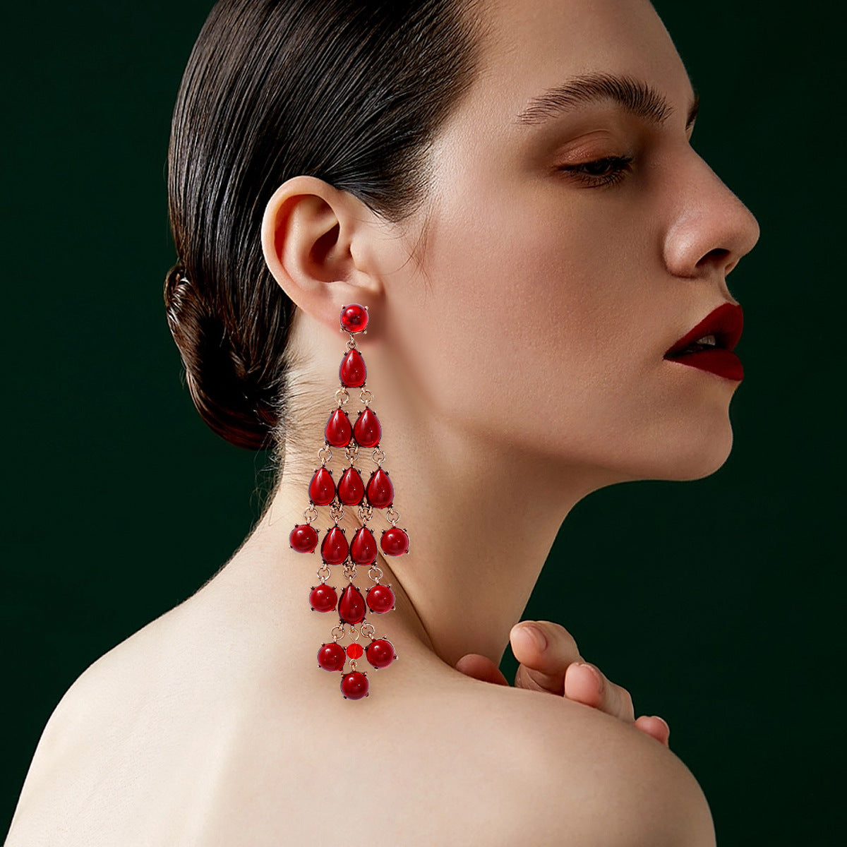 Alloy & Rhinestone teardrop earrings in red worn by woman with dark hair and makeup