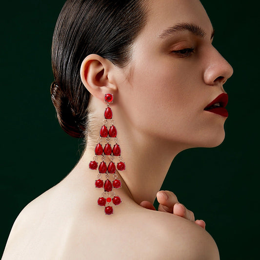 Alloy & Rhinestone teardrop earrings in red worn by woman with dark hair and makeup