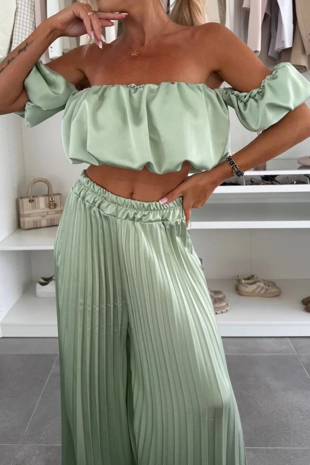 Light green off-shoulder ruffled top and pleated pants two-piece set