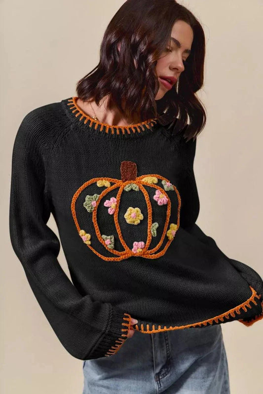 black cozy sweater with embroidered pumpkin floral design and orange trim modeling Pumpkin Floral Thanksgiving Sweater