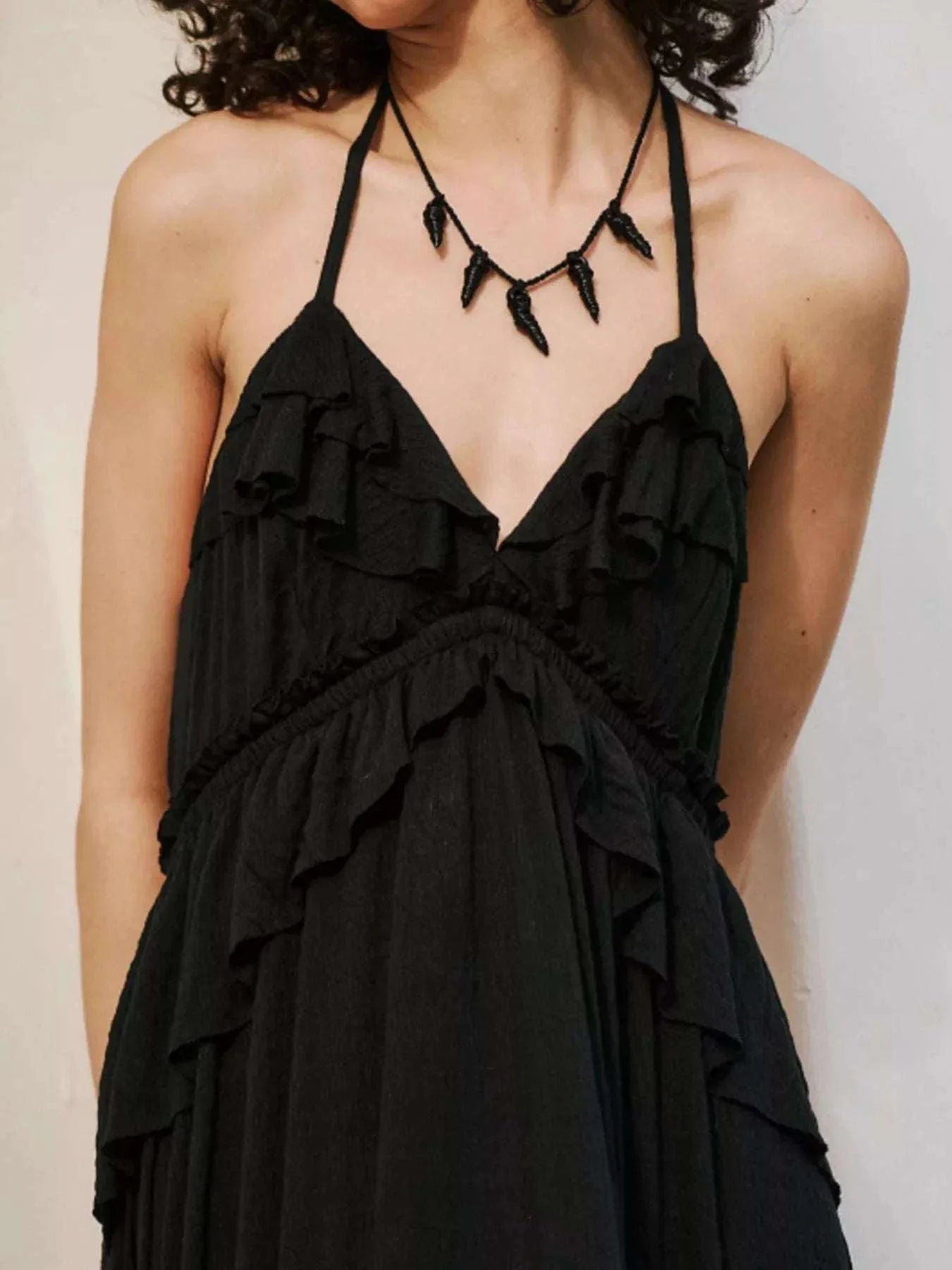 black ruffled halter neck maxi dress with tied straps and layered ruffles