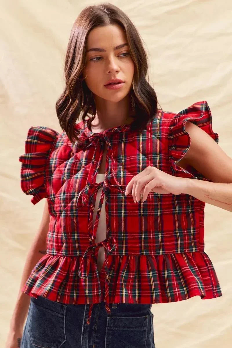 Woman wearing red Christmas holiday plaid ruffled quilt vest top with ties and ruffle details