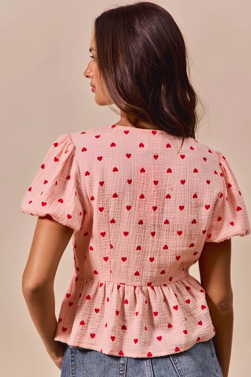 Back view of pink baby doll blouse with all over red heart print and ribbon tie detail