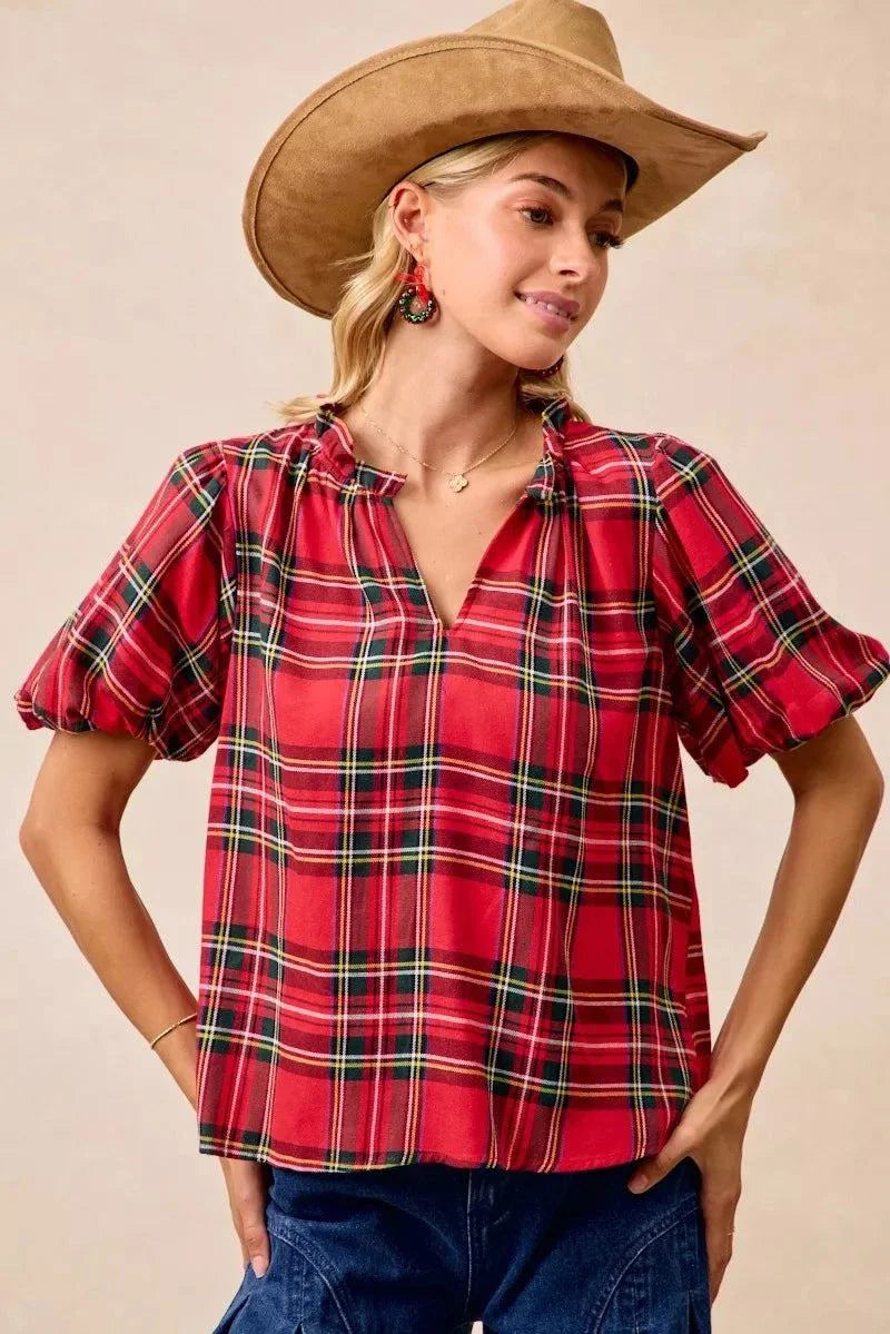 BiBi Christmas Plaid Short Sleeves Ruffled BlouseThis Christmas plaid short sleeves ruffled blouse is a festive and charming addition to your holiday wardrobe. The classic plaid pattern evokes a cheerful and cozy hChristmas plaid blouse