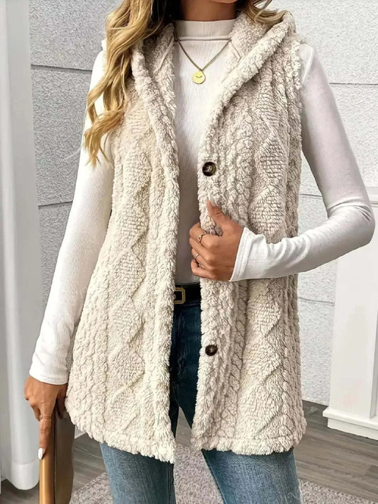 woman wearing beige button up plush hooded vest with cable knit design over white long sleeve top