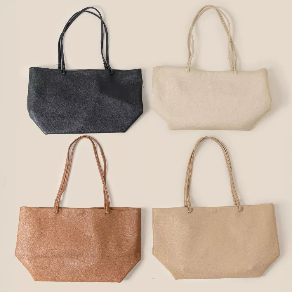 Set of four Fame Soft Solid Color Tote Bags in black, cream, brown, and beige with leather texture and shoulder straps