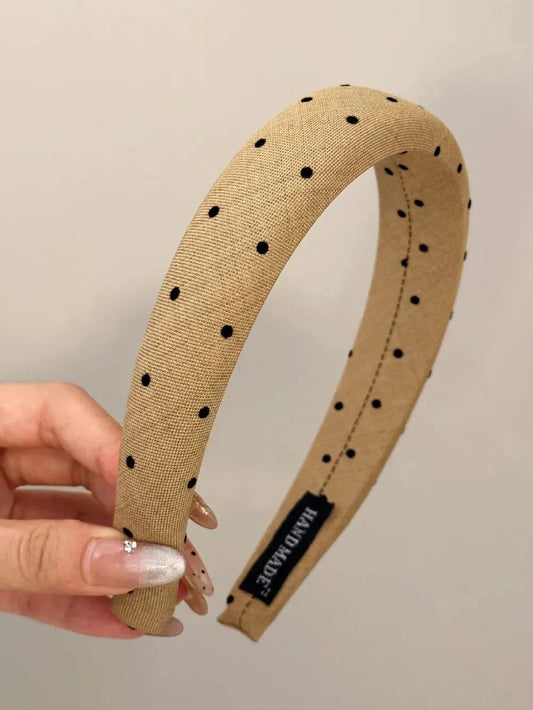 Polka dot polyester wide headband beige with black dots hand held