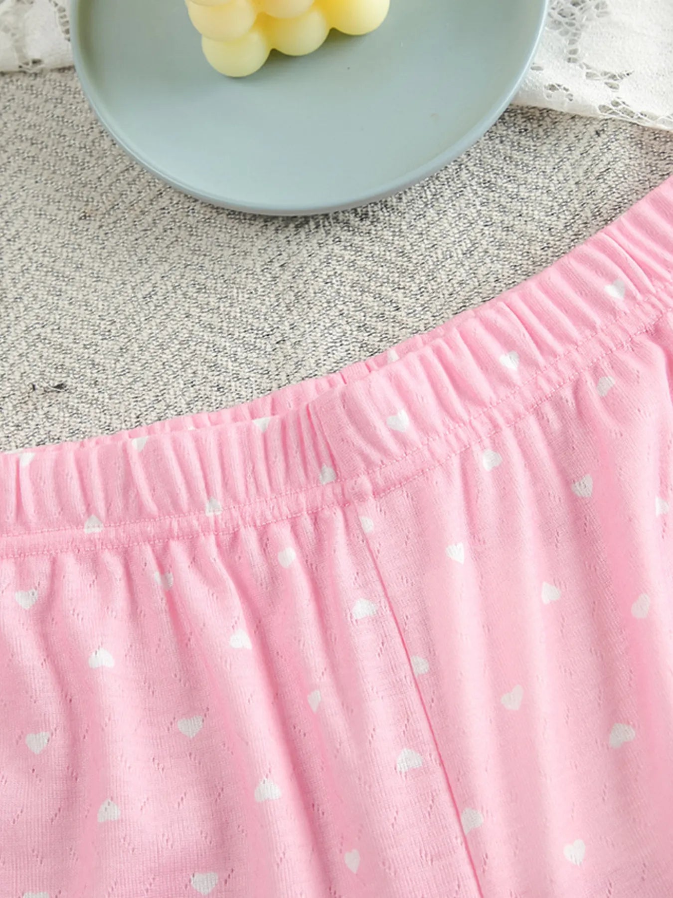 Close-up of pink polka dot round neck top and pants lounge set with elastic waistband