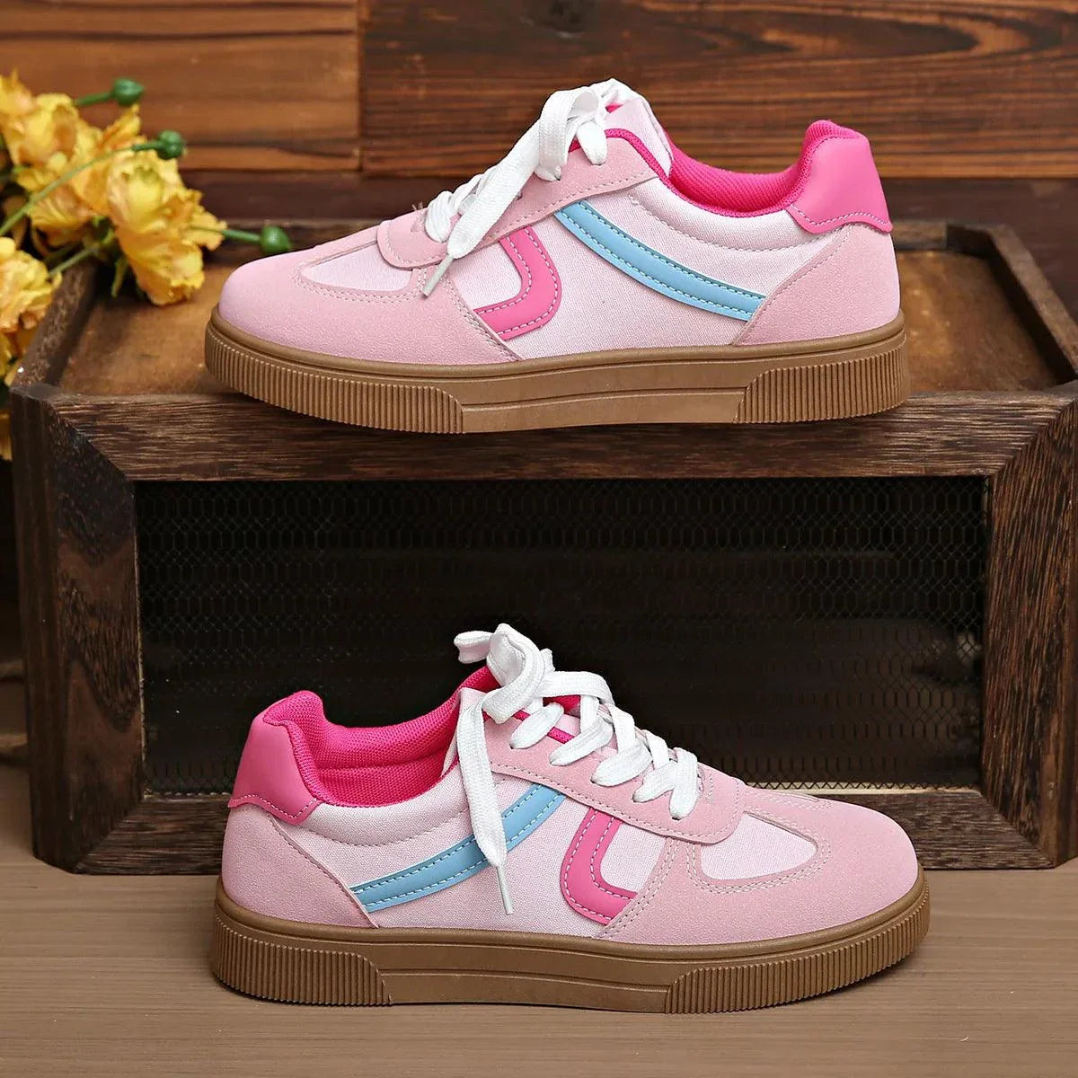Pink and blue lace up platform sneakers with white laces and brown rubber sole