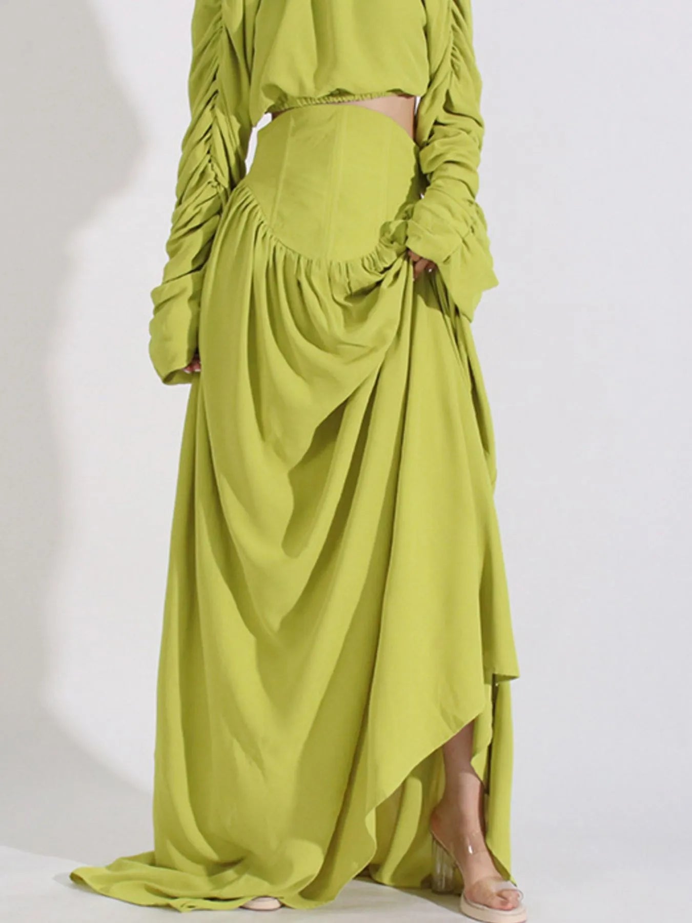 Green ruched long sleeve top paired with high waist draped skirt set