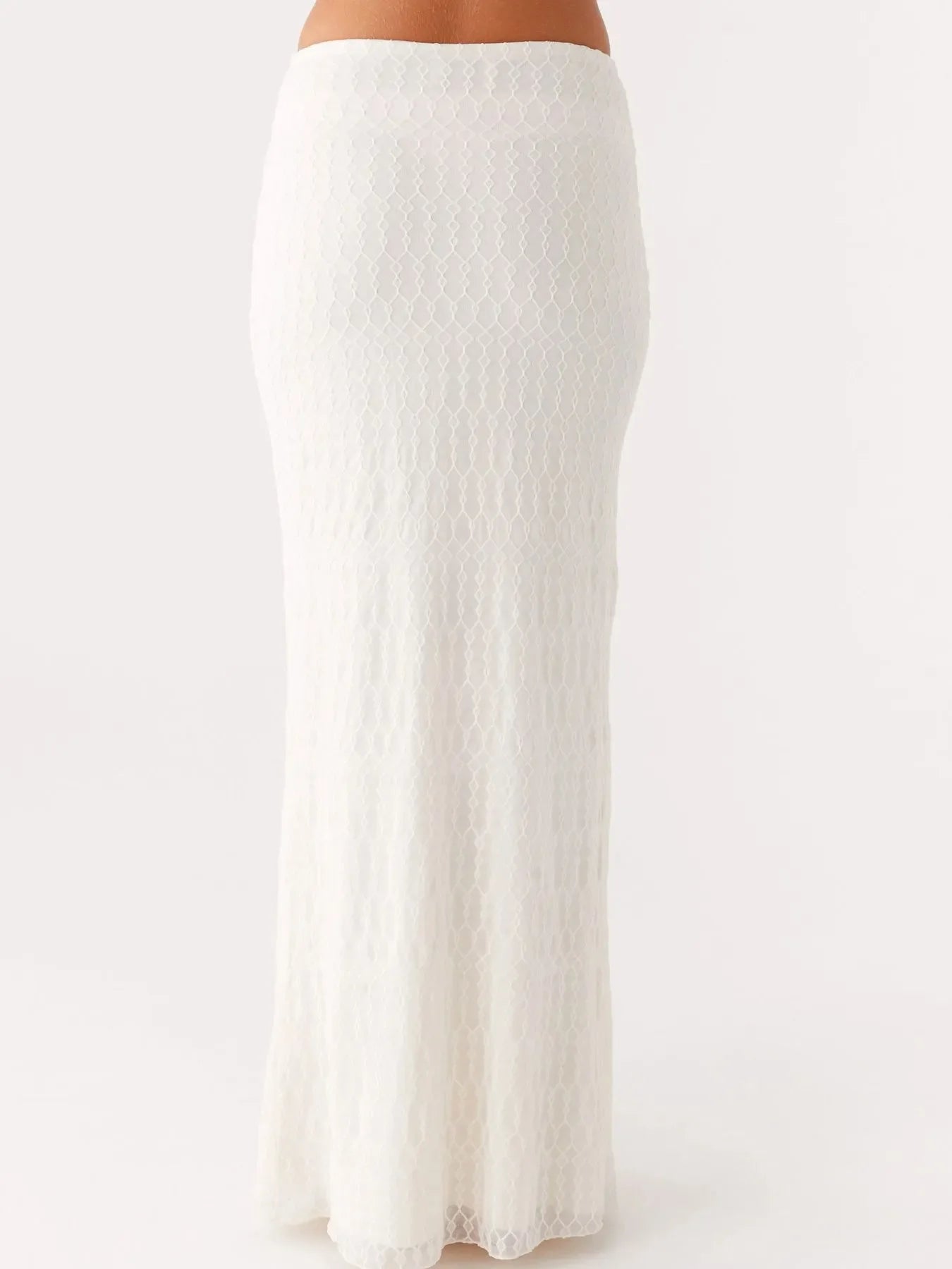 White lace maxi skirt from a tie front tube top and maxi skirt set, made of slightly stretchy polyester, two-piece outfit.