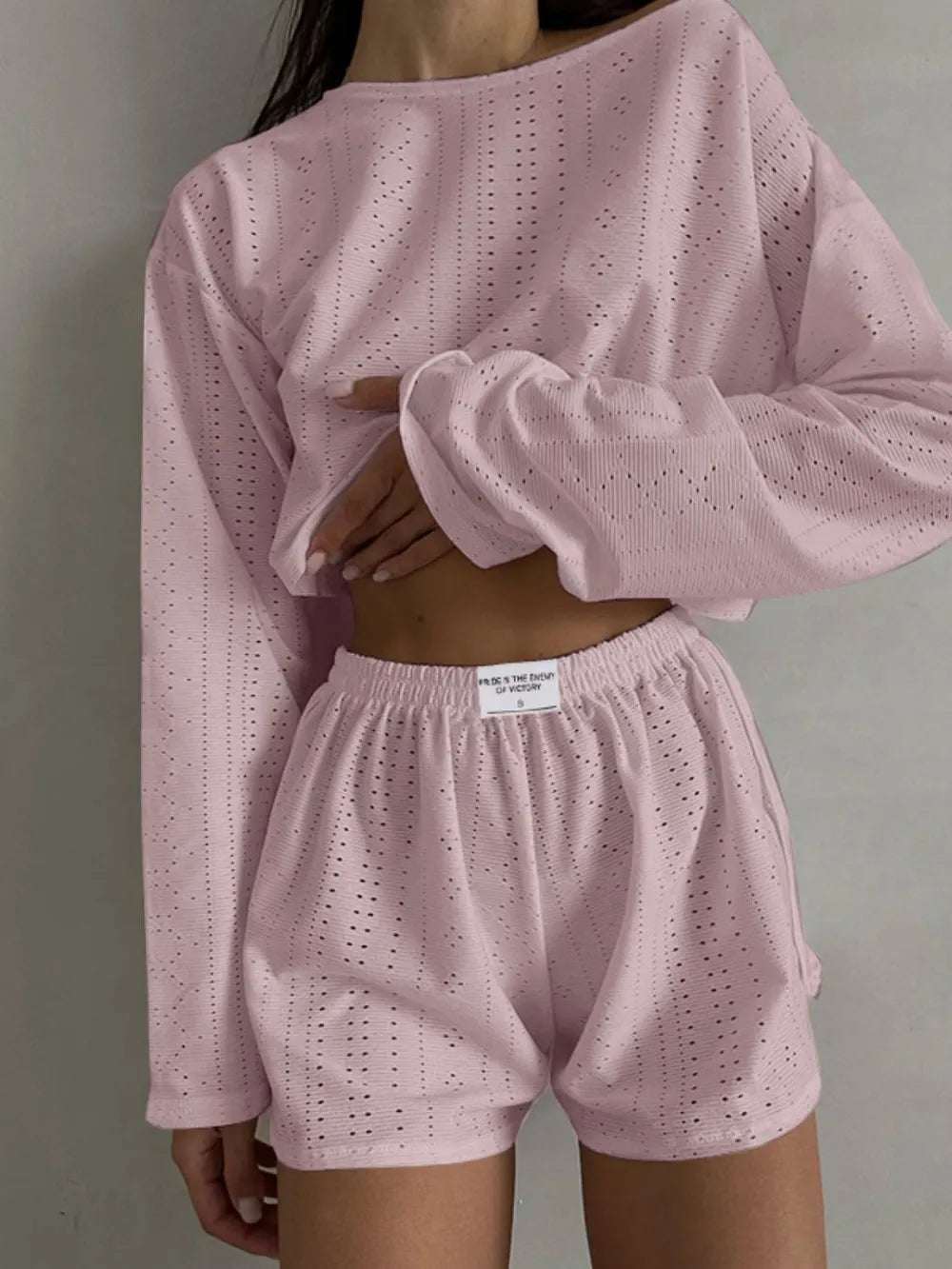 Light pink eyelet round neck top and matching shorts set with long sleeves and elastic waistband